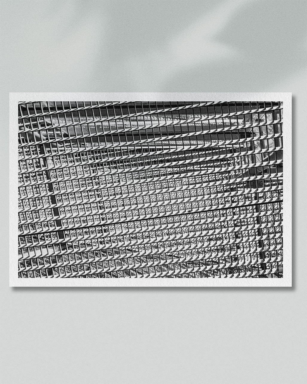 Framed presentation of repeating architectural lines rendered in black and white