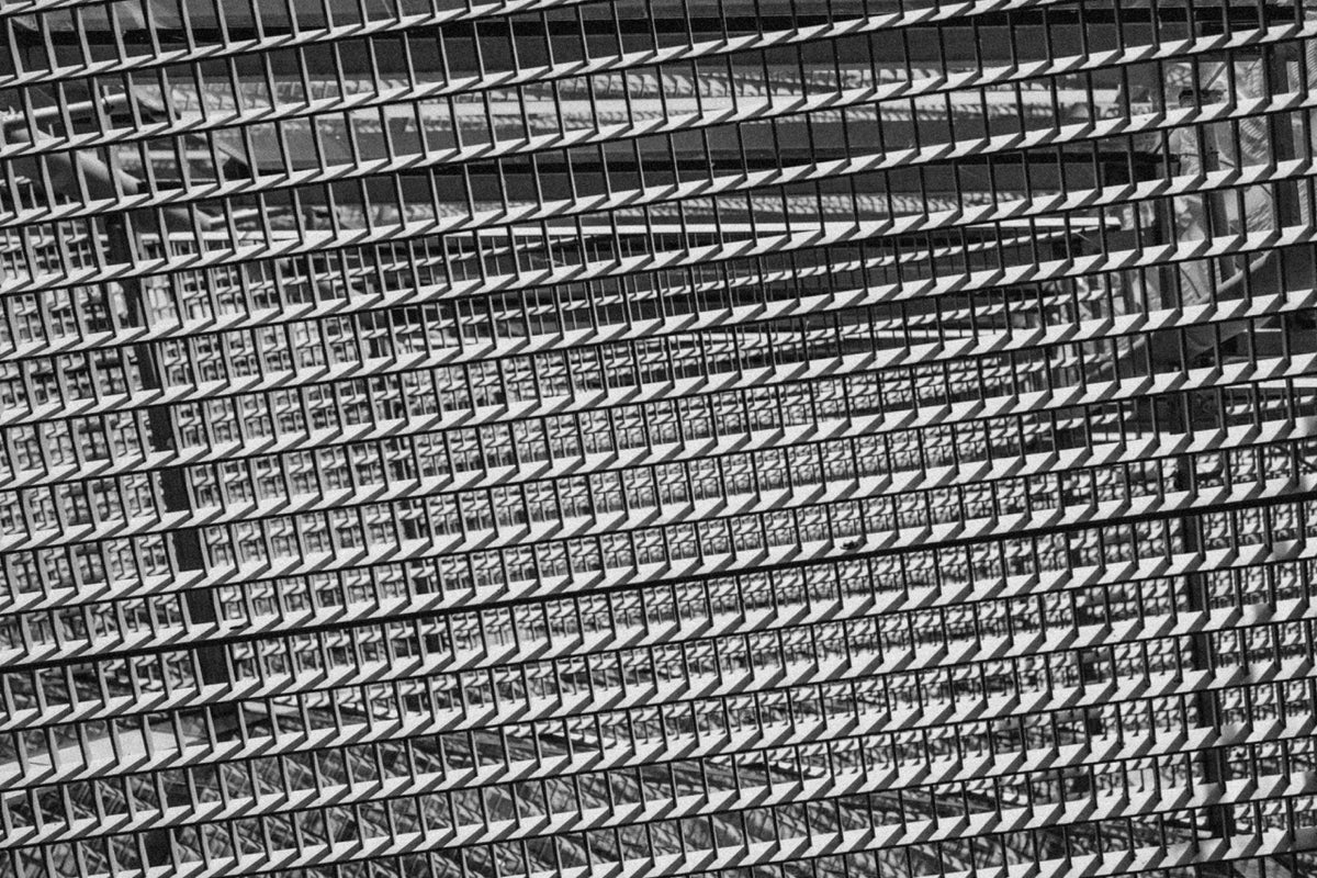 repeating architectural lines rendered in black and white, photographed by Mitchel Lensink