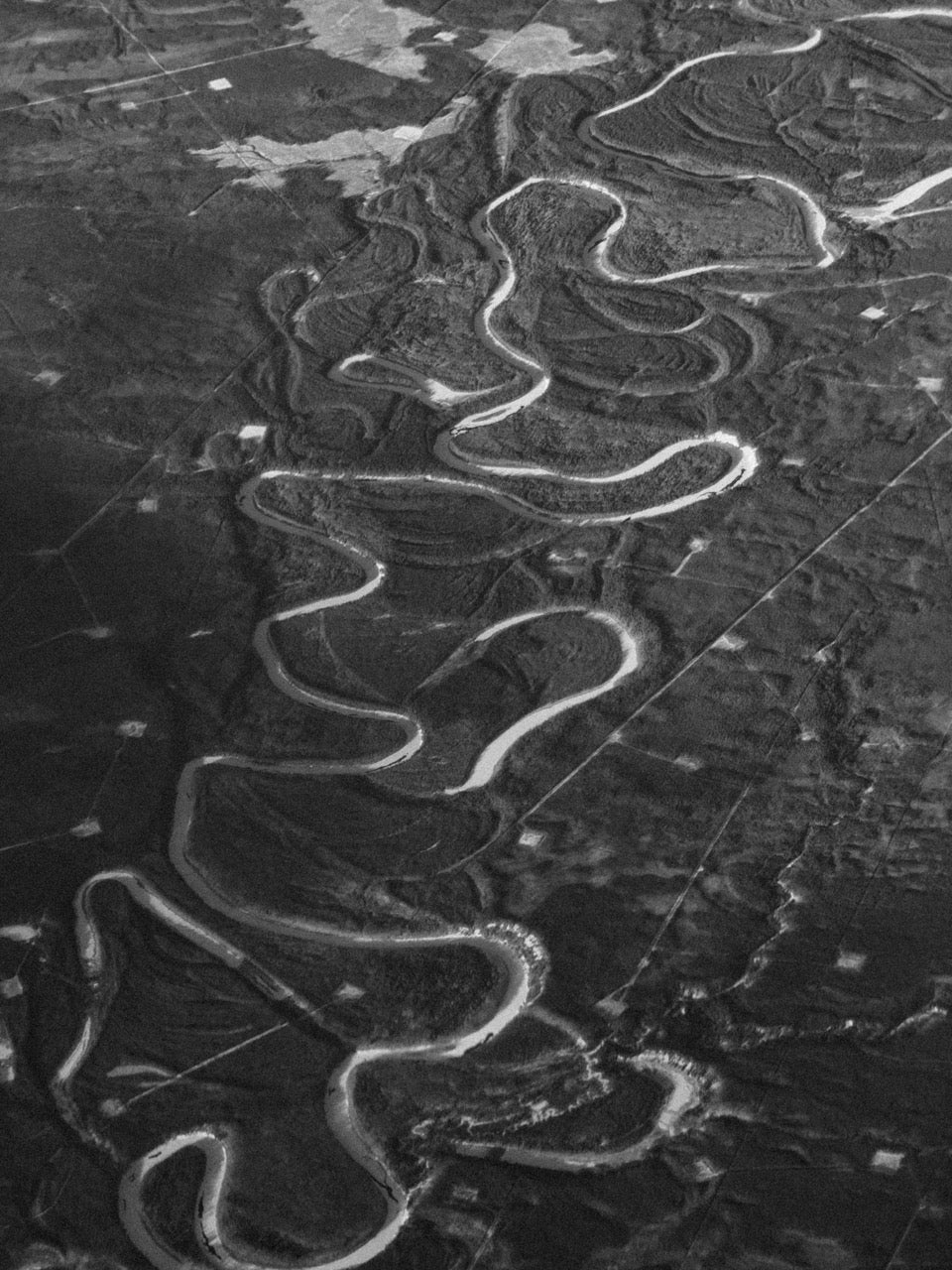 a winding Canadian landscape photographed from the air, photographed by Mitchel Lensink